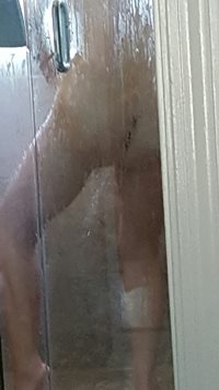 Snuck a few pics of wife shaving her pussy in the shower...not very clear t...