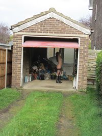 Garage door open so anyone passing by can give the slut a fucking.