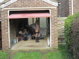 Garage door open so anyone passing by can give the slut a fucking.
