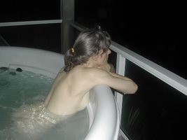 Bergie looking out over the Pacific Ocean from a dramatic hot tub view perc...