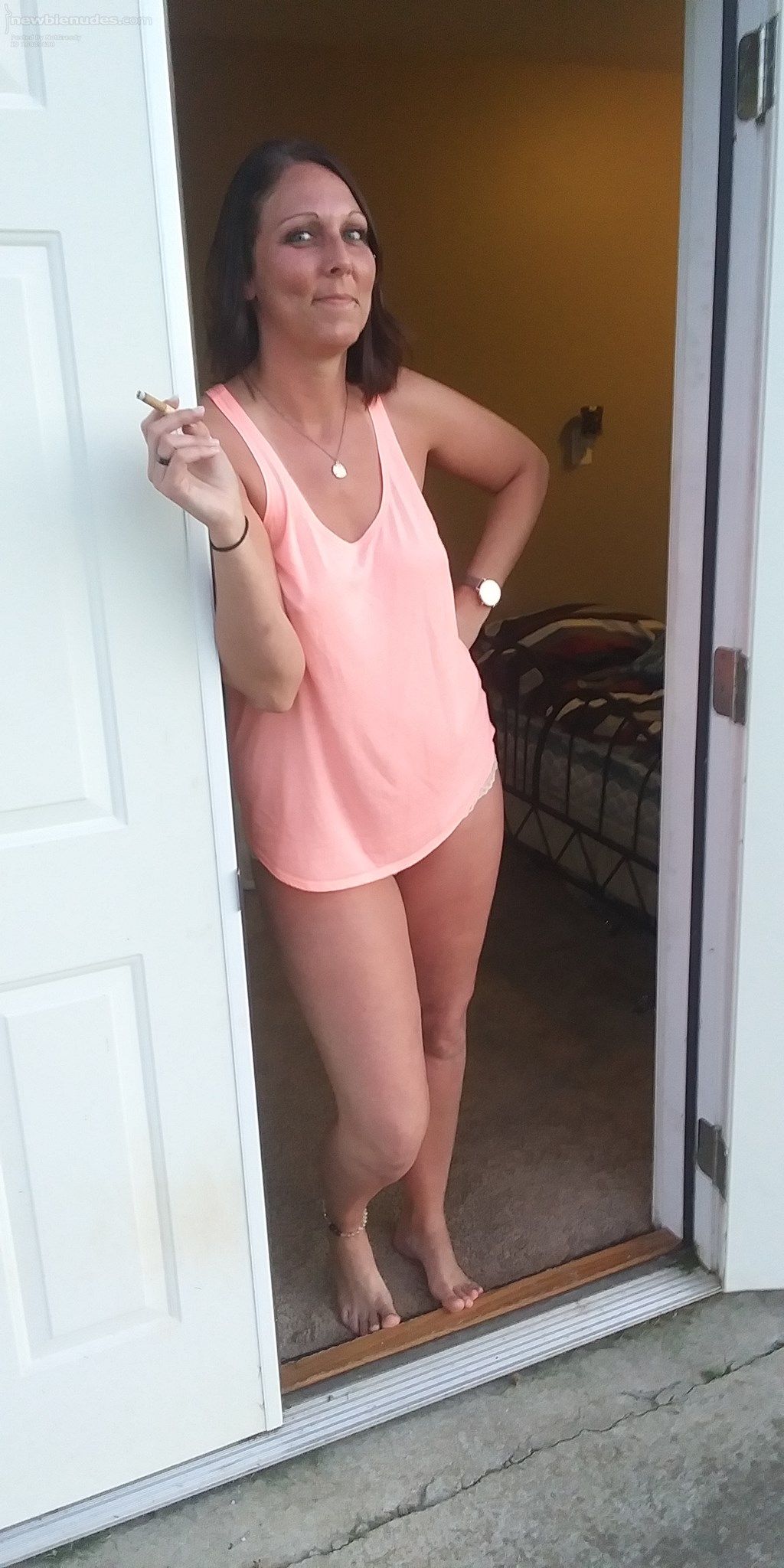 Outside smoking with nothing but a loose fitting shirt