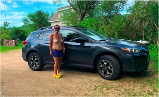 Missy Stands Next To Subaru Crosstrek With Boobs Out
