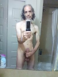 Holding it in the mirror. (See videos for my latest masturbation video that...