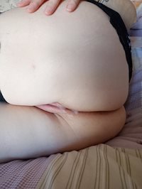 Lying on my side with cum leaking out of me.......