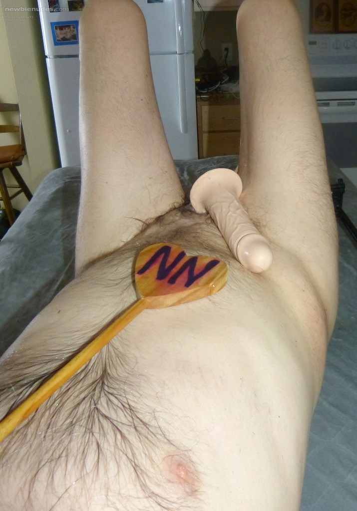 A view from chest level from my right side with my knees up as I take a break from toy play with my dick still inside the toy... and I am on my kitchen island...late April 2025.