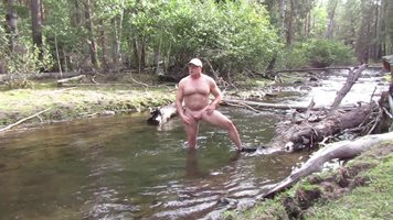 Naked and bathing in the mountain stream.