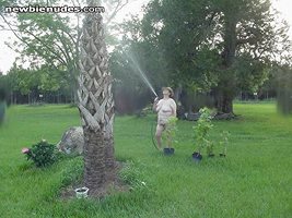 Wife watering the palms. We love being outside naked. Dixie & hubby come jo...
