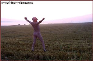 Nude and happy in a cornfield at sun-up