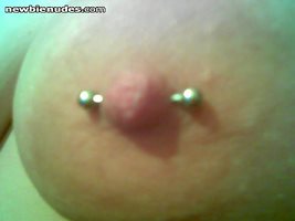 her newly pierced nipple.