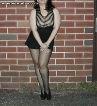 Posing outside in a sheer shirt and skirt