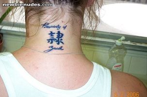 She had ink done to attest her devotion. Slave Kanji with "property of" tat...
