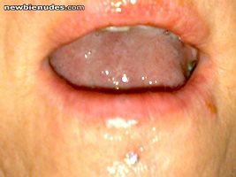 My gf's tongue coated with my cum.  Anyone wanna give it a 2nd coat?