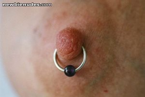 a close up of Cheryls pierced nipple