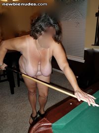 Playing pool nude.