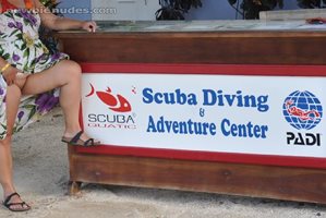 My wife flashing at the scuba stand!