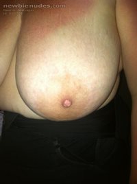 Wife's big tit waiting to be sucked on.
