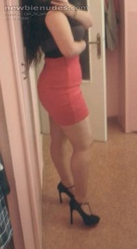 Tight red skirt and heels. She usually wears this without panties for me.