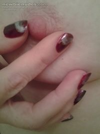 fingernails and a rosy nipple